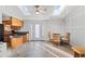 Open concept dining area with kitchen access, skylights, and wood flooring at 360 Linda Ln, Denver, CO 80221