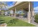 Covered back patio with seating area, ceiling fan, and access to backyard at 3214 Heron Lakes Pkwy, Berthoud, CO 80513