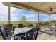 Back porch with table and chairs, overlooking a scenic open space at 3214 Heron Lakes Pkwy, Berthoud, CO 80513