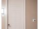 Apartment entrance with a modern white door and thermostat at 12983 W Ida Ave # 201, Littleton, CO 80127