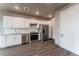 Modern kitchen with white cabinets and stainless steel appliances at 12983 W Ida Ave # 201, Littleton, CO 80127