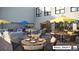 Outdoor patio with comfortable seating and umbrellas at 12983 W Ida Ave # 201, Littleton, CO 80127