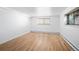 Bedroom with hardwood floors and two windows at 1 S Pennsylvania St # 104, Denver, CO 80209