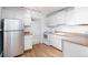 White kitchen with stainless steel appliances at 1 S Pennsylvania St # 104, Denver, CO 80209