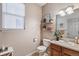 Clean bathroom with wood vanity and shelving at 6650 Sunburst Ave, Firestone, CO 80504