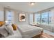 Bright and airy bedroom with large windows and a cozy sitting area at 1765 Peak Loop, Broomfield, CO 80023