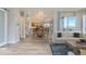 Open concept dining room with light wood floors and view into kitchen at 1765 Peak Loop, Broomfield, CO 80023