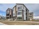 Modern three-story townhome with stone and siding at 1765 Peak Loop, Broomfield, CO 80023