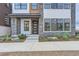 Townhome exterior with stone and modern front door at 1765 Peak Loop, Broomfield, CO 80023