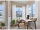 Bright home office features a modern desk, chair, and large windows offering plenty of natural light at 1765 Peak Loop, Broomfield, CO 80023
