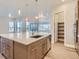 Modern kitchen with large island, quartz countertops, and stainless steel appliances at 1765 Peak Loop, Broomfield, CO 80023