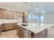 Modern kitchen with large island, stainless steel appliances, and ample cabinet space at 1765 Peak Loop, Broomfield, CO 80023