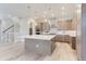 Open kitchen boasts an island, stainless steel appliances, and hardwood floors at 1765 Peak Loop, Broomfield, CO 80023