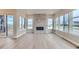 Light-filled living room features hardwood floors and a modern fireplace at 1765 Peak Loop, Broomfield, CO 80023