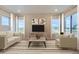 Living room featuring two sofas, a coffee table and large windows at 1765 Peak Loop, Broomfield, CO 80023