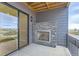 Outdoor patio with a stone fireplace and sliding glass door at 1765 Peak Loop, Broomfield, CO 80023