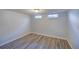 Finished basement room with light blue walls, wood-look flooring, and two windows at 40 S Chase Dr, Lakewood, CO 80226