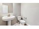 Simple bathroom with white pedestal sink and toilet at 16870 Mckay Dr, Mead, CO 80542