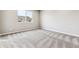 Upstairs bedroom with grey carpet and a large window at 16870 Mckay Dr, Mead, CO 80542