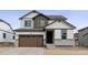 Two-story home with brown accents and a two-car garage at 16870 Mckay Dr, Mead, CO 80542