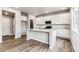 Modern kitchen with white cabinets, quartz countertops, and an island at 16870 Mckay Dr, Mead, CO 80542