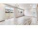 Bright living room with large windows and wood-look floors at 16870 Mckay Dr, Mead, CO 80542