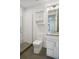 Modern bathroom with a glass shower, toilet, and granite countertops at 4273 E 8Th Ave, Denver, CO 80210