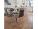 Modern glass dining table with four gray chairs in an open concept kitchen at 4273 E 8Th Ave, Denver, CO 80210