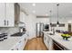 Modern kitchen with white cabinets, stainless steel appliances, and a large island at 42960 Colonial Trl, Elizabeth, CO 80107