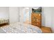 A cozy bedroom featuring a patterned bedspread, wooden dresser, and a TV at 1005 W 7Th Ave Dr, Broomfield, CO 80020