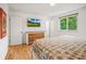 Main bedroom with king-size bed, wood floors, and natural light from large window at 1005 W 7Th Ave Dr, Broomfield, CO 80020