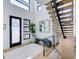 Bright and airy entryway with modern staircase and bench at 4224 E Dickenson Pl, Denver, CO 80222