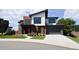 Modern two-story home with wood and white siding, landscaped yard, and attached garage at 4224 E Dickenson Pl, Denver, CO 80222