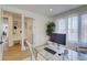 Bright home office features built-in shelving and a glass desk at 4224 E Dickenson Pl, Denver, CO 80222