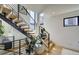 Modern staircase with metal railing and wooden steps at 4224 E Dickenson Pl, Denver, CO 80222