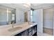 Primary bathroom with double vanity, walk-in shower, and closet at 14382 Mosaic Ave, Parker, CO 80134