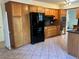 Kitchen with wood cabinets, granite countertops, and black appliances at 2789 S Ivan Way, Denver, CO 80227