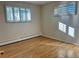 Well-lit bedroom with hardwood floors and window shutters at 2789 S Ivan Way, Denver, CO 80227