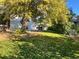 Landscaped backyard with large tree at 2789 S Ivan Way, Denver, CO 80227