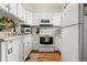 Efficient kitchen with white cabinets and modern appliances at 1811 S Quebec Way # 134, Denver, CO 80231