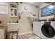Convenient laundry room with washer, dryer, and utility sink at 1811 S Quebec Way # 134, Denver, CO 80231