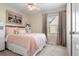 Charming bedroom featuring a queen-size bed and large window at 1811 S Quebec Way # 134, Denver, CO 80231