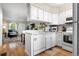 Open kitchen with white cabinets, granite countertops, and views to the living room at 1811 S Quebec Way # 134, Denver, CO 80231
