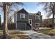 Two-story house with gray siding, attached garage, and a well-maintained yard at 2048 Spencer St, Longmont, CO 80501