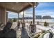 Covered patio with outdoor furniture, overlooking a snowy backyard and homes at 2627 Hillcroft Ln, Castle Rock, CO 80104