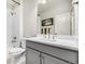 Modern bathroom with gray vanity, white countertop, and herringbone tile at 2627 Hillcroft Ln, Castle Rock, CO 80104