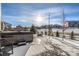 Hot tub and fire pit in snow-covered backyard at 2627 Hillcroft Ln, Castle Rock, CO 80104