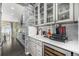 Kitchen with a beverage bar, wine fridge, and stone accent wall at 2627 Hillcroft Ln, Castle Rock, CO 80104