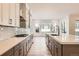 Modern kitchen with gray and white cabinets, stainless steel appliances and large island at 11442 Autumn Moon St, Littleton, CO 80125