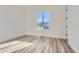 Bright bedroom with hardwood floors and a large window at 11442 Autumn Moon St, Littleton, CO 80125